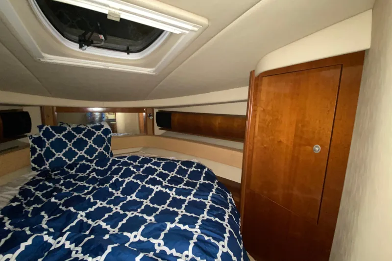 Slide: The Image of Luxurious cabin interior of 2005 Sea Ray 500 Sundancer yacht with patterned bedding. - 41