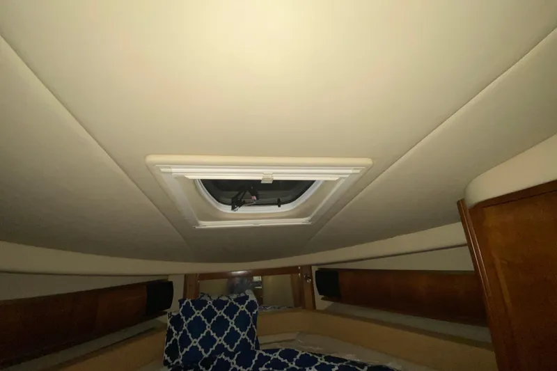 Slide: The Image of Interior cabin of 2005 Sea Ray 500 Sundancer with skylight and patterned bedding. - 42