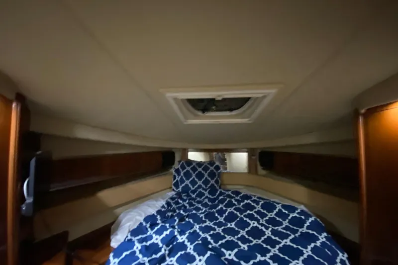 Slide: The Image of Interior cabin of 2005 Sea Ray 500 Sundancer with blue patterned bedding. - 47