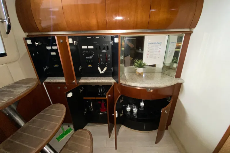 Slide: The Image of Interior of 2005 Sea Ray 500 Sundancer yacht with open cabinets and stairs. - 49