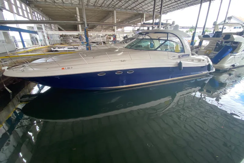 Slide: The Image of 2005 Sea Ray 500 Sundancer yacht docked in a marina, featuring a sleek blue and white design. - 5