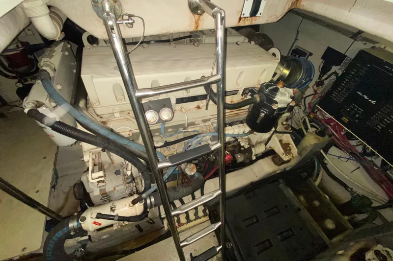 Slide: The Image of Engine room of a 2005 Sea Ray 500 Sundancer yacht, showcasing mechanical components. - 54