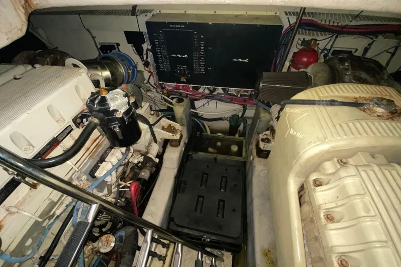 Slide: The Image of Engine room of a 2005 Sea Ray 500 Sundancer, showcasing mechanical components and wiring. - 55