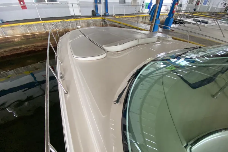 Slide: The Image of 2005 Sea Ray 500 Sundancer yacht in indoor marina, showcasing sleek deck design. - 8