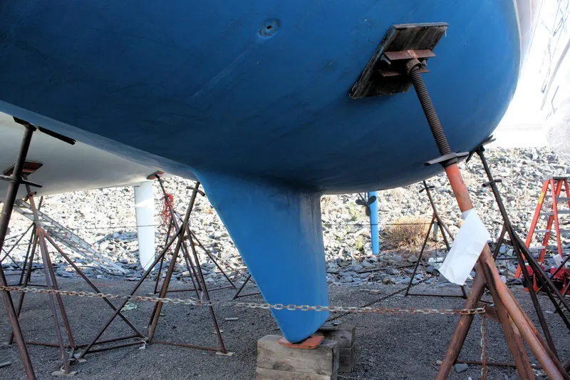 Slide: The Image of 1986 Catalina 36 sailboat hull supported by stands in a boatyard. - 10