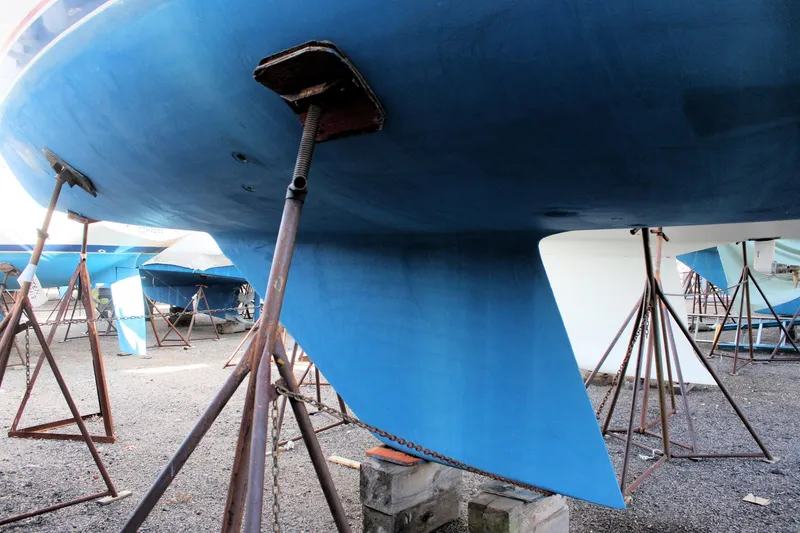 Slide: The Image of Underwater view of a 1986 Catalina 36 sailboat hull on stands in a boatyard. - 12