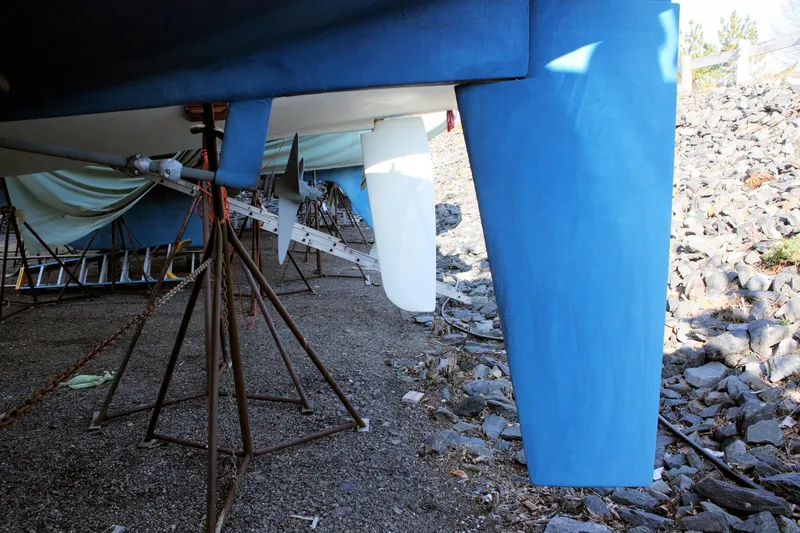 Slide: The Image of 1986 Catalina 36 sailboat keel and propeller on dry dock, supported by stands. - 13