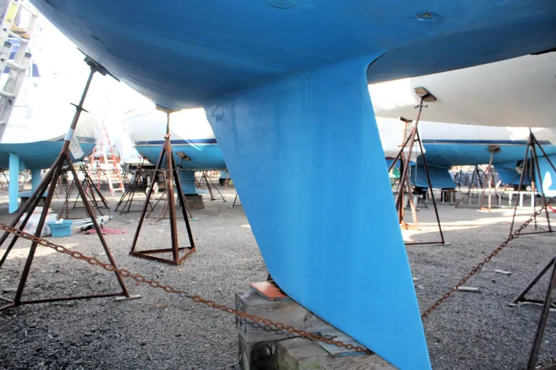 Slide: The Image of Catalina 36 sailboat keel, 1986 model, in dry dock with support stands. - 14
