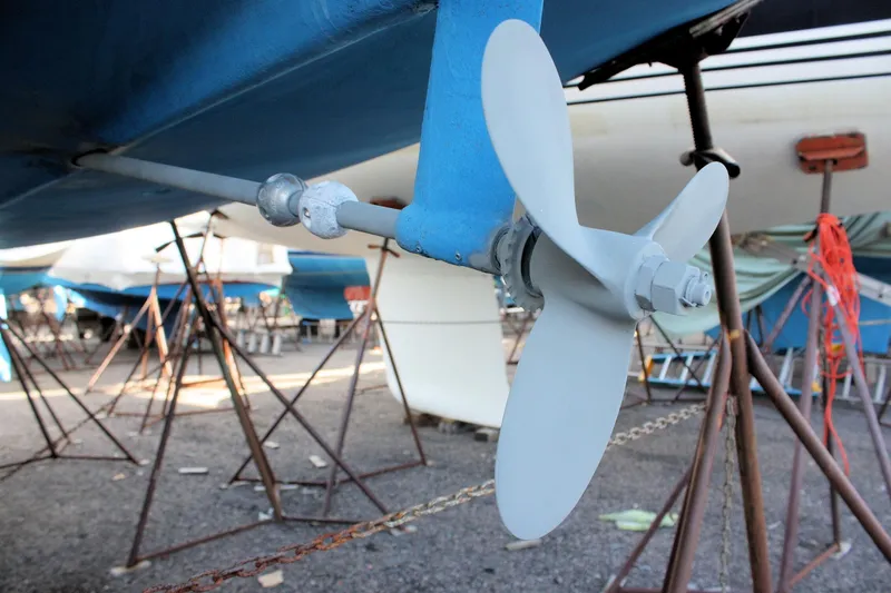 Slide: The Image of Propeller of a 1986 Catalina 36 sailboat on dry dock, surrounded by support stands. - 16
