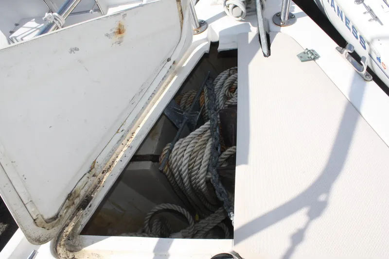 Slide: The Image of Open storage compartment on 1986 Catalina 36 sailboat, containing ropes and anchor equipment. - 18