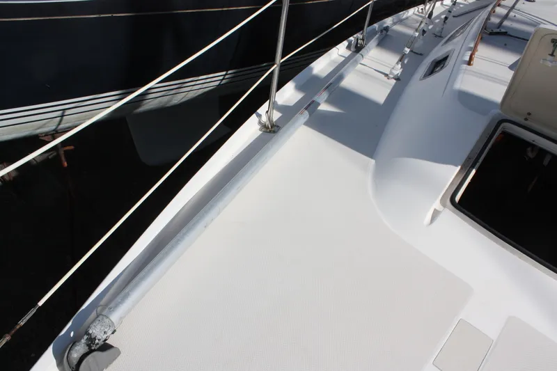 Slide: The Image of Deck view of a 1986 Catalina 36 sailboat, featuring open hatch and railing. - 19