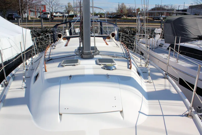 Slide: The Image of 1986 Catalina 36 sailboat docked, showcasing deck and mast in marina setting. - 20