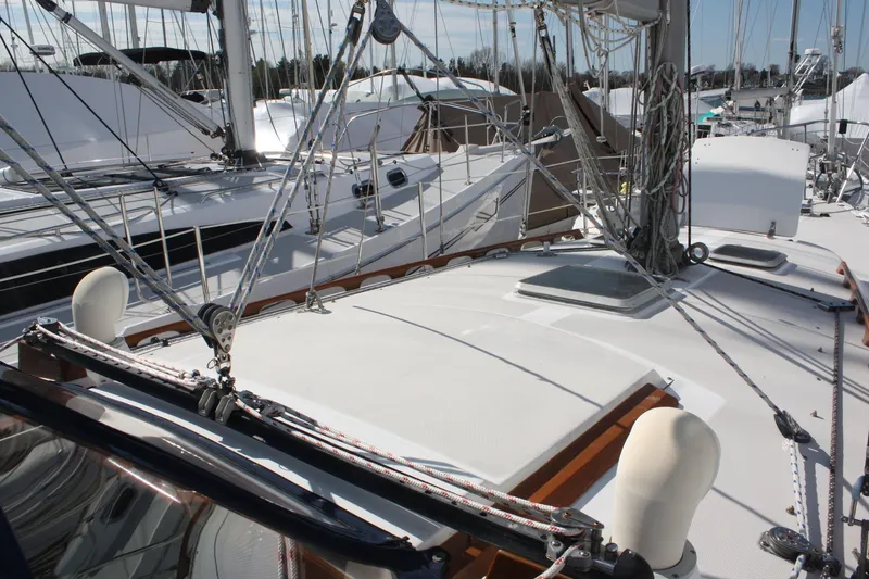 Slide: The Image of 1986 Catalina 36 sailboat deck with rigging and hatches in a marina setting. - 22