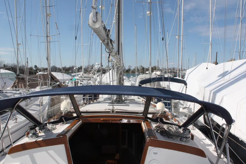 Slide: The Image of 1986 Catalina 36 sailboat docked, view from cockpit, surrounded by other boats. - 26