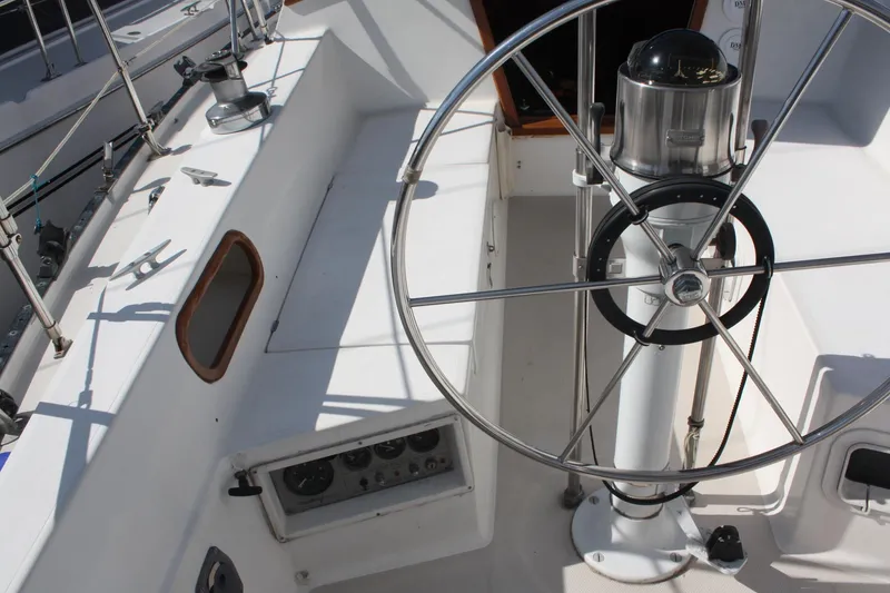Slide: The Image of Cockpit of 1986 Catalina 36 sailboat with steering wheel and navigation instruments. - 27