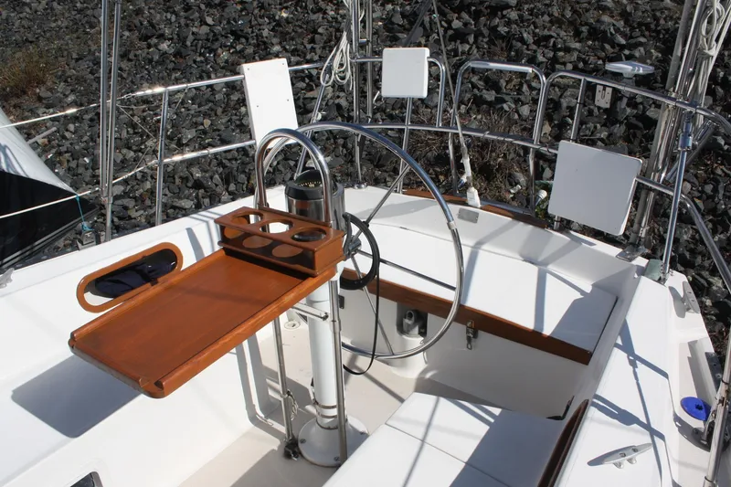 Slide: The Image of Cockpit of a 1986 Catalina 36 sailboat with wooden table and steering wheel. - 29