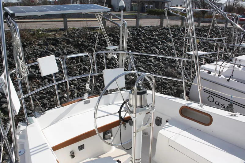 Slide: The Image of Cockpit of a 1986 Catalina 36 sailboat with steering wheel and solar panels. - 30