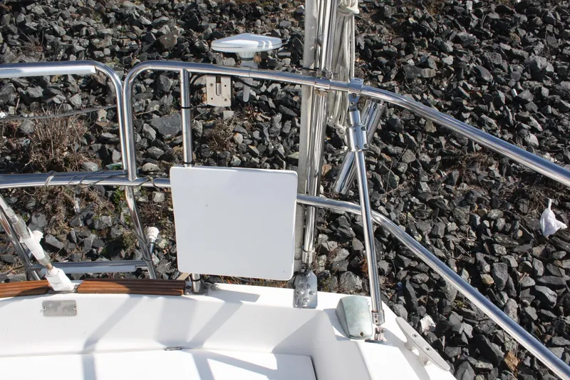Slide: The Image of Sailboat deck of 1986 Catalina 36 with stainless steel railings and rocky shoreline background. - 31