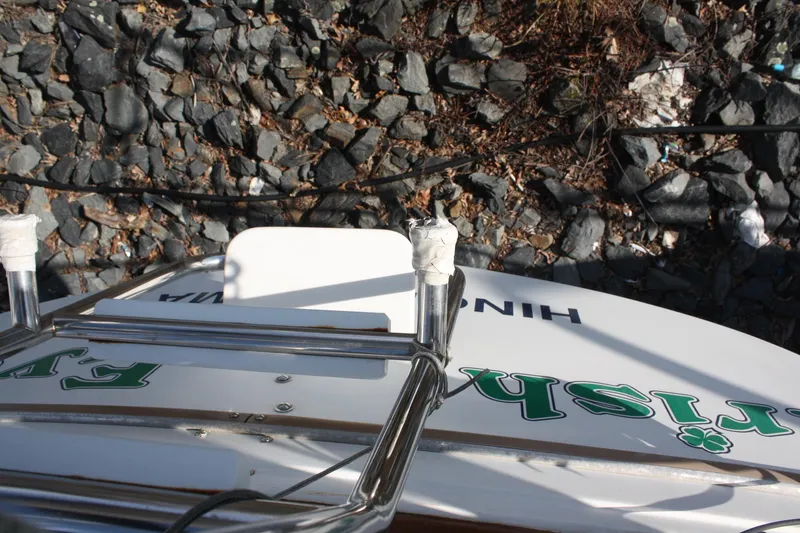 Slide: The Image of Catalina 36 sailboat from 1986, docked near rocky shoreline. - 32