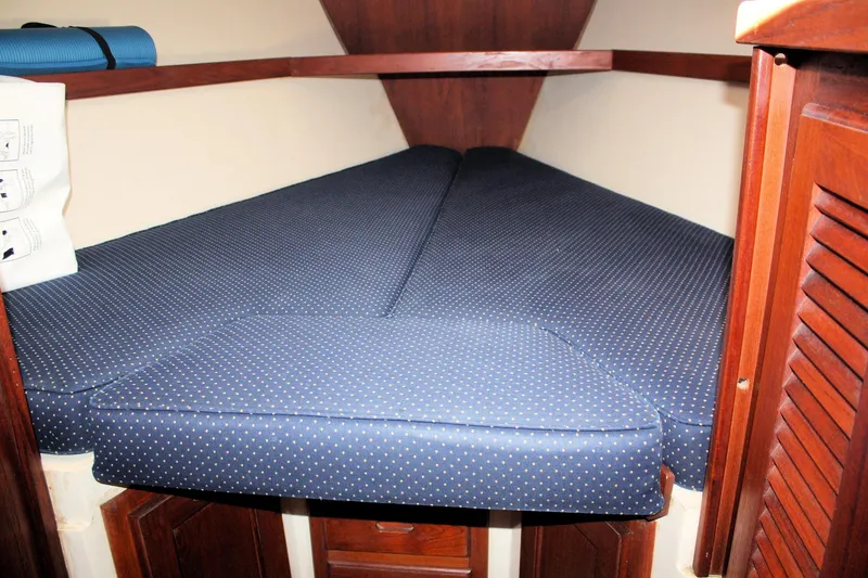 Slide: The Image of V-berth cabin interior of 1986 Catalina 36 sailboat with blue polka dot cushions. - 36