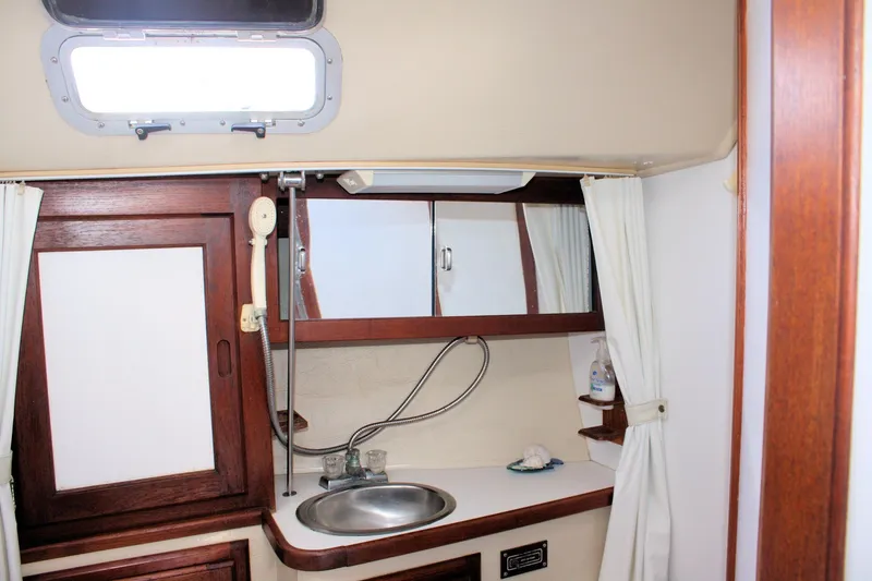 Slide: The Image of Interior of 1986 Catalina 36 sailboat bathroom with sink and wooden accents. - 39