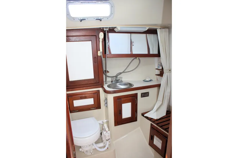 Slide: The Image of 1986 Catalina 36 yacht bathroom with wooden cabinets and compact design. - 41