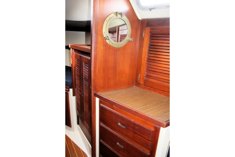 Slide: The Image of Interior of 1986 Catalina 36 sailboat with wooden cabinetry and porthole. - 43