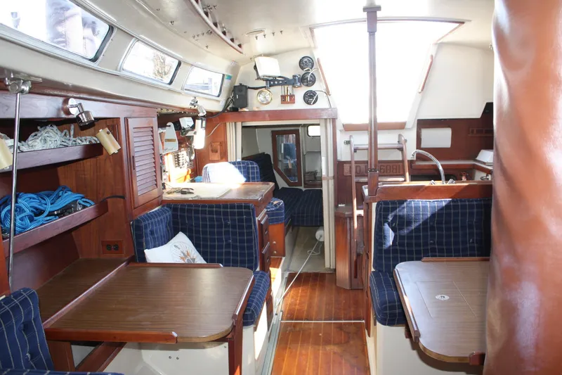 Slide: The Image of Interior of a 1986 Catalina 36 sailboat with wood finishes and blue upholstery. - 44