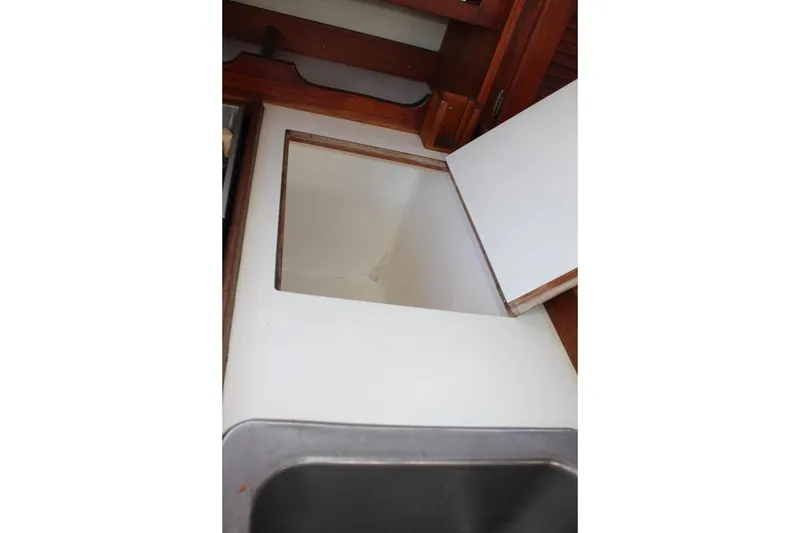 Slide: The Image of Interior view of 1986 Catalina 36 sailboat galley with open storage compartment. - 53
