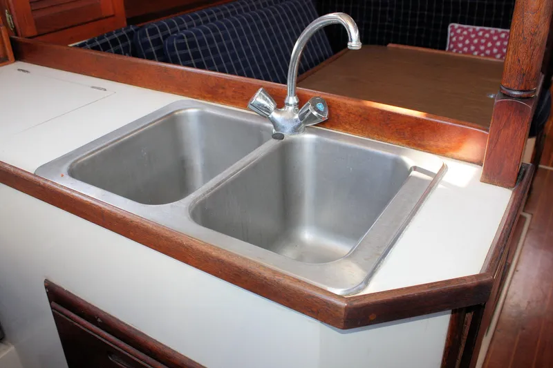 Slide: The Image of Double sink in 1986 Catalina 36 yacht kitchen with wooden trim. - 55