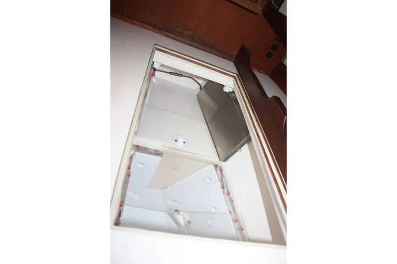 Slide: The Image of Interior view of a 1986 Catalina 36 sailboat compartment with storage space. - 56