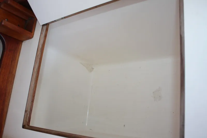 Slide: The Image of Empty storage compartment on a 1986 Catalina 36 sailboat. - 58