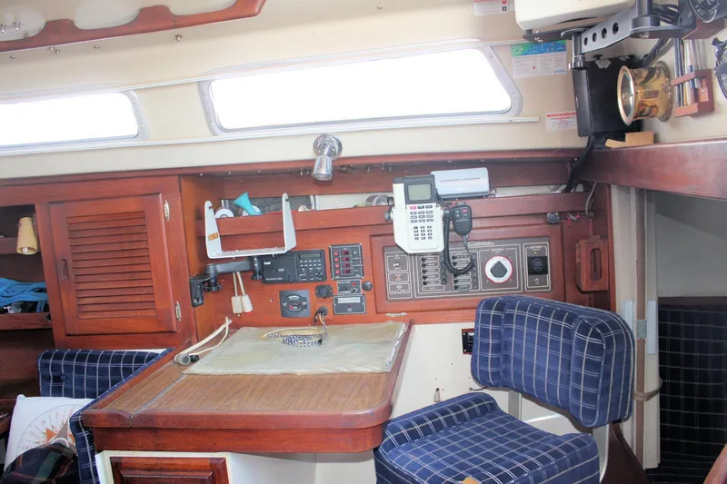 Slide: The Image of Interior of a 1986 Catalina 36 sailboat with navigation equipment and wooden cabinetry. - 61