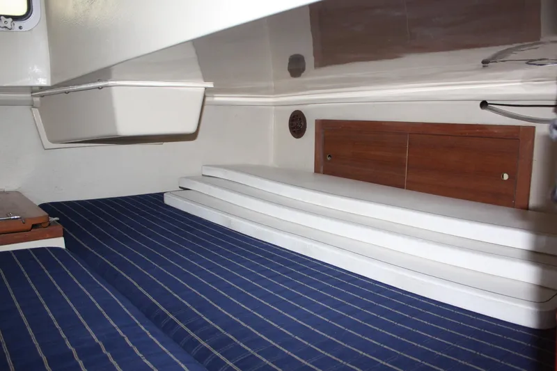 Slide: The Image of Interior cabin of a 1986 Catalina 36 sailboat with striped bedding. - 64