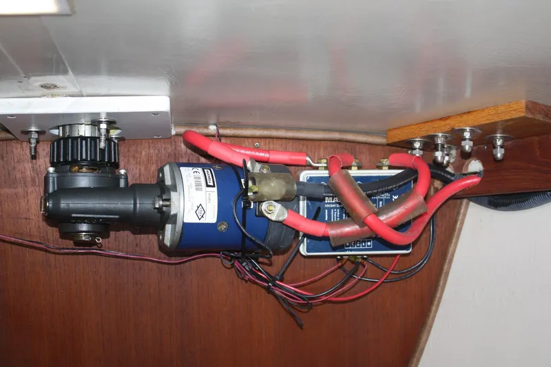 Slide: The Image of Electrical system components inside a 1986 Catalina 36 sailboat, featuring wiring and motor assembly. - 69