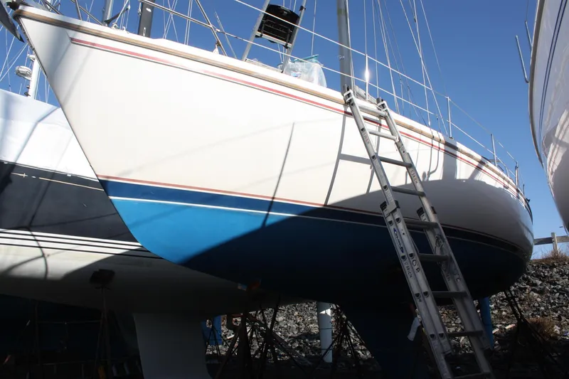 Slide: The Image of 1986 Catalina 36 sailboat on dry dock with ladder, blue and white hull. - 7