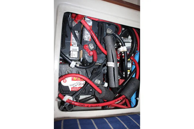 Slide: The Image of Battery compartment of a 1986 Catalina 36 sailboat with red and black cables. - 70