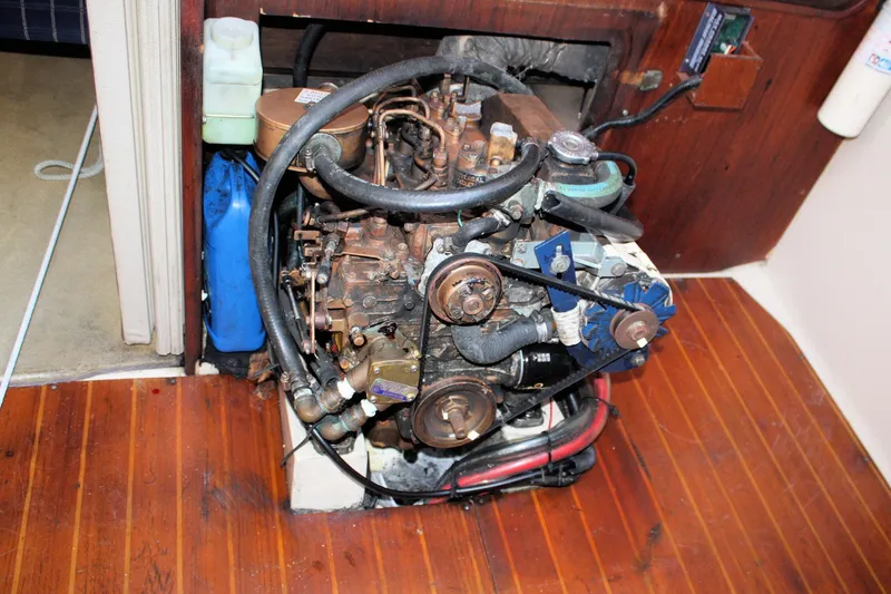 Slide: The Image of Engine compartment of a 1986 Catalina 36 sailboat, featuring a well-maintained marine engine. - 73