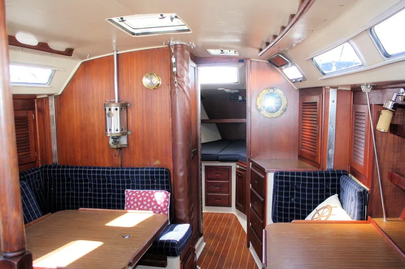Slide: The Image of Interior of a 1986 Catalina 36 sailboat with wood paneling and cozy seating area. - 80