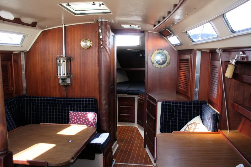 Slide: The Image of Interior of a 1986 Catalina 36 sailboat with wood paneling and seating area. - 81