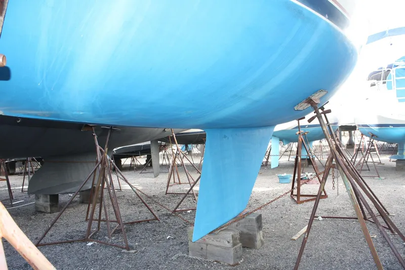 Slide: The Image of 1986 Catalina 36 sailboat hull on stands in a boatyard. - 9