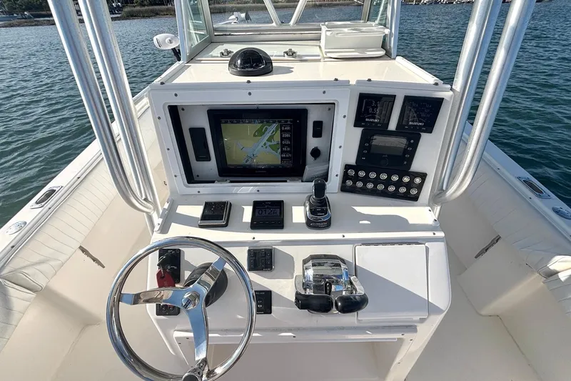 Slide: The Image of 2004 Regulator 26 Classic boat dashboard with navigation and control systems on water. - 5