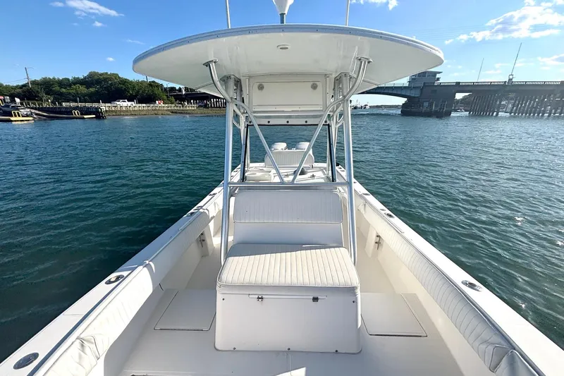 Slide: The Image of 2004 Regulator 26 Classic boat on water near a bridge, clear sky. - 7