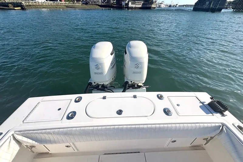 Slide: The Image of 2004 Regulator 26 Classic boat with twin Suzuki 300 outboard engines on water. - 9