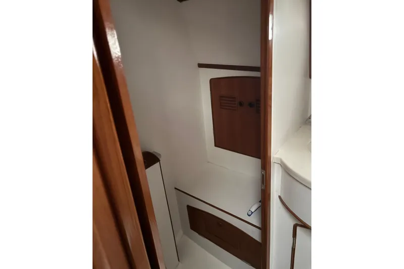 Slide: The Image of Interior of 1990 Little Harbor 36 yacht, featuring wooden cabinetry and compact design. - 13