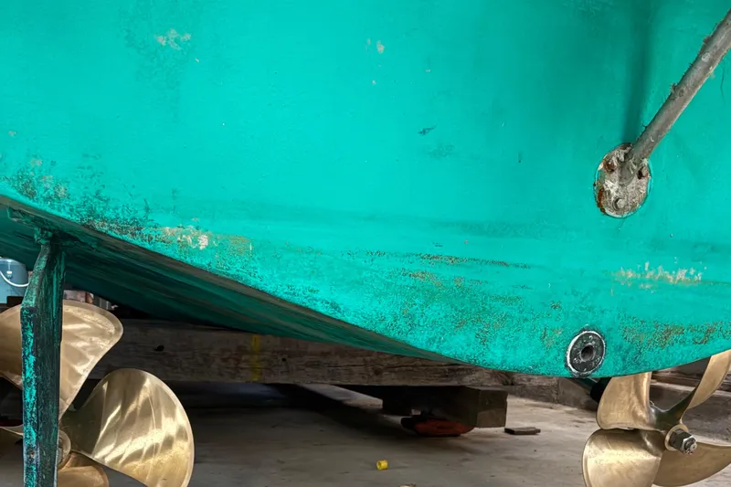 Slide: The Image of Close-up of a 1990 Little Harbor 36 boat hull with visible propellers. - 14
