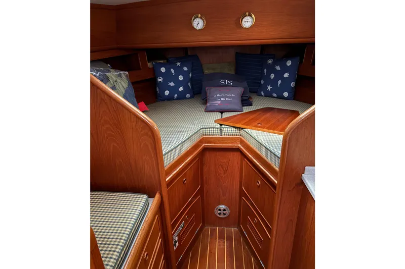 Slide: The Image of Cozy cabin interior of 1990 Little Harbor 36 yacht with wooden finish and nautical pillows. - 6