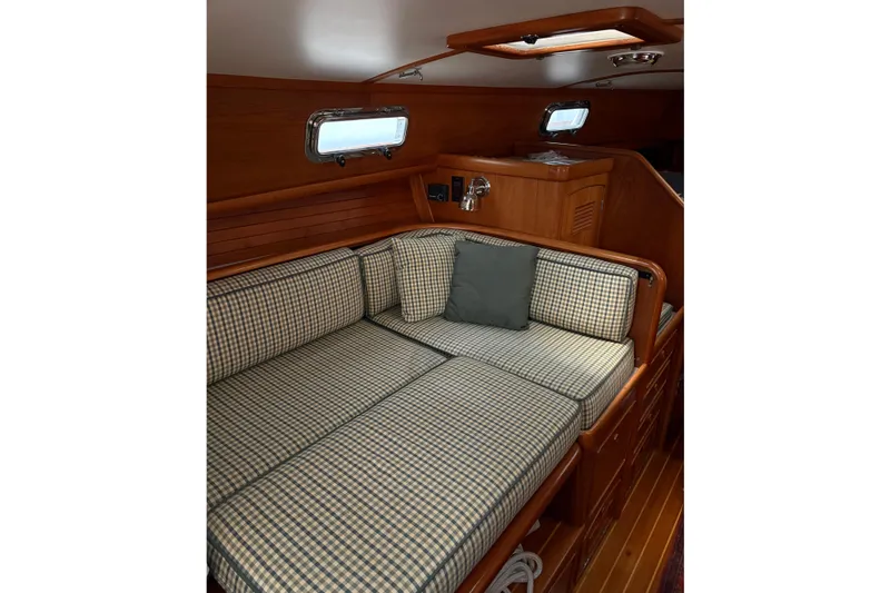 Slide: The Image of Cozy cabin interior of 1990 Little Harbor 36 yacht with checkered cushions. - 9