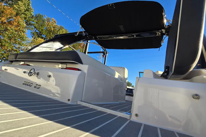 Slide: The Image of 2019 Regal 2000 ES Bowrider boat with open canopy, viewed from the rear on a sunny day. - 21