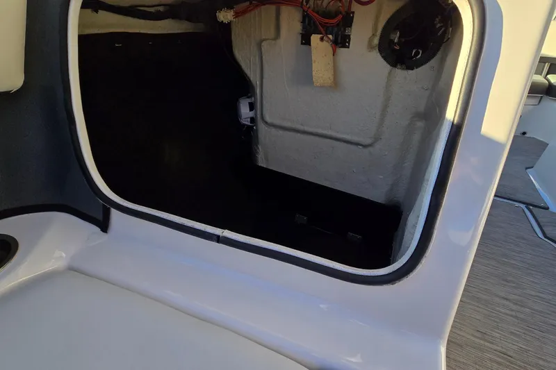 Slide: The Image of Open storage compartment in 2019 Regal 2000 ES Bowrider boat, showcasing interior wiring. - 52